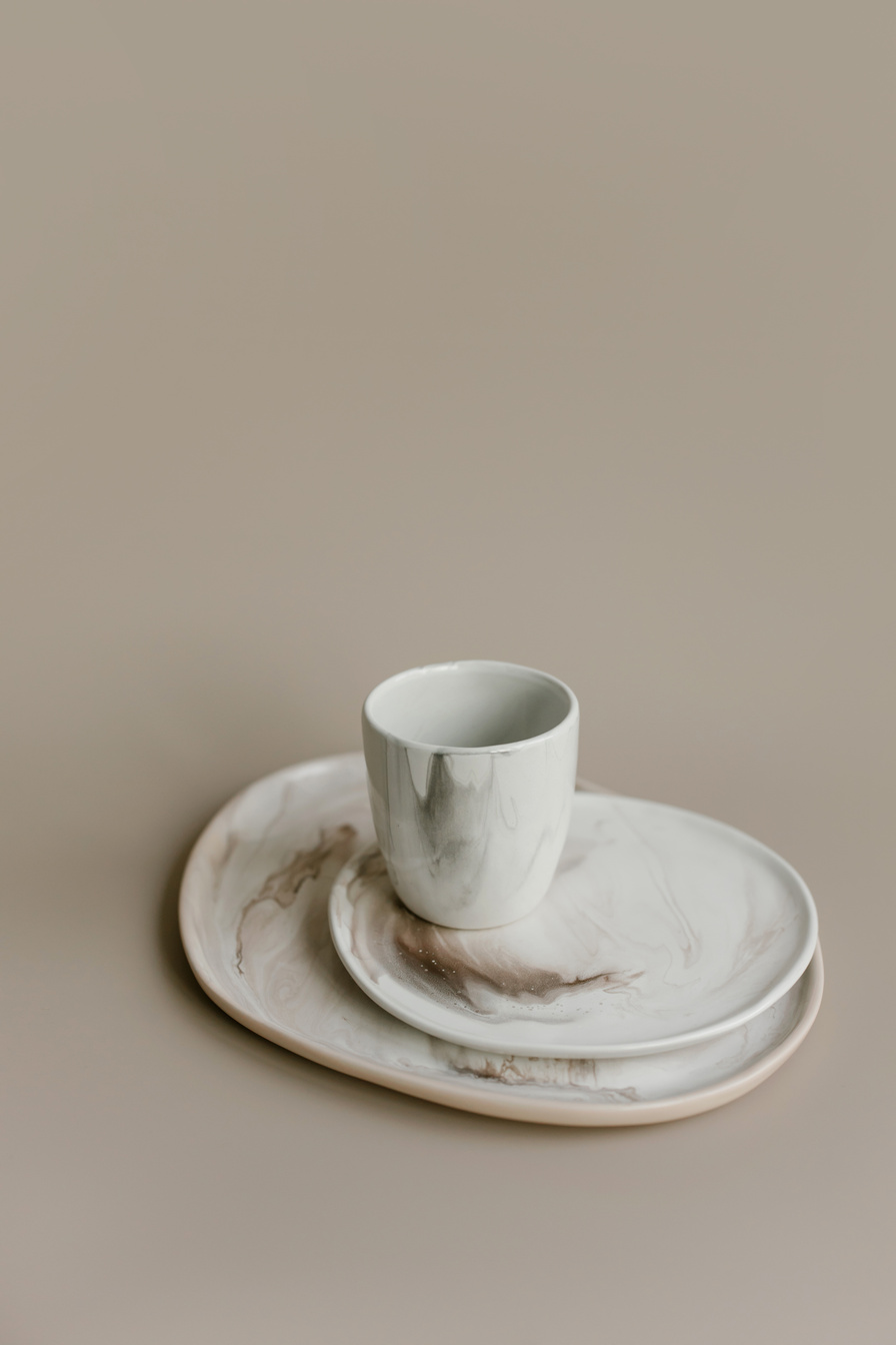 Photograph of a Ceramic Cup on Top of Ceramic Plates